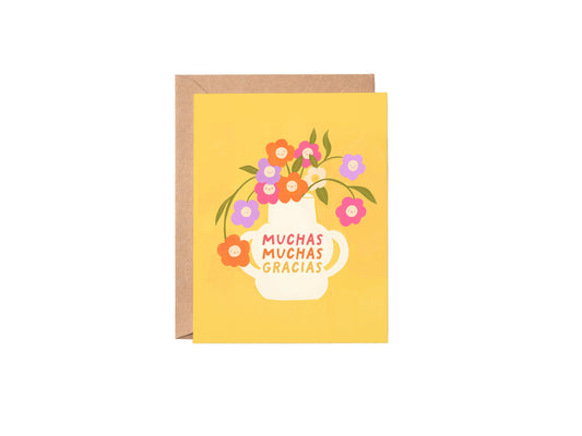 Greeting card with floral design and 'Muchas Gracias' text on a yellow background