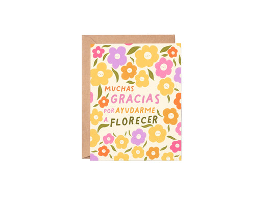 Greeting card with floral design and Spanish text on a white background