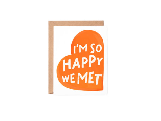 Greeting card with red heart and text 'I'm so happy we met' on a white background